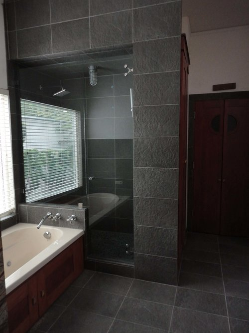 a bathroom with black tiles