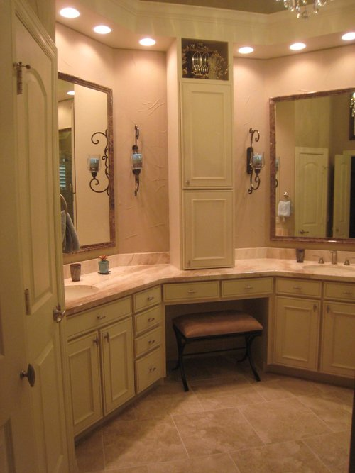 a vintage bathroom with soft green cabinets