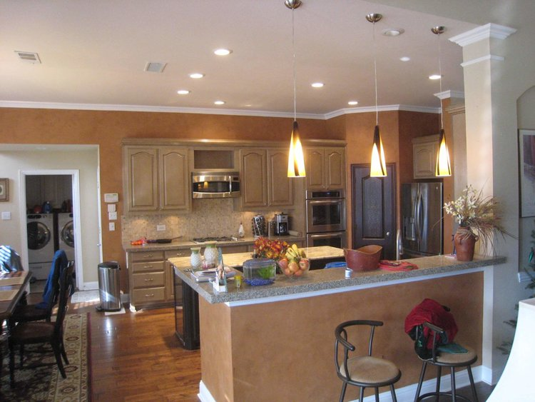 Custom kitchen remodeling with vintage cabinets, sleek countertops, and wooden flooring