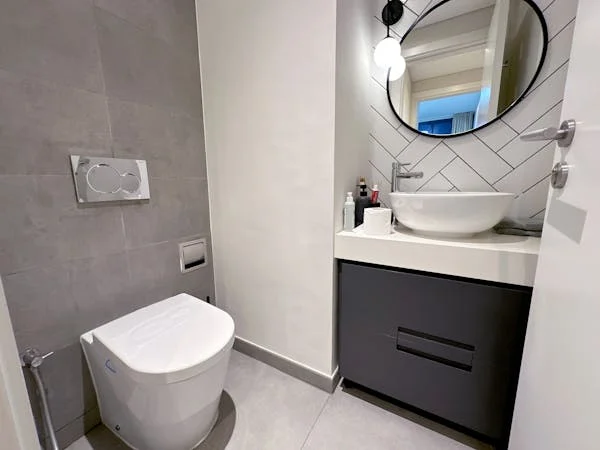 Small custom vanity with an integrated sink for maximizing space.