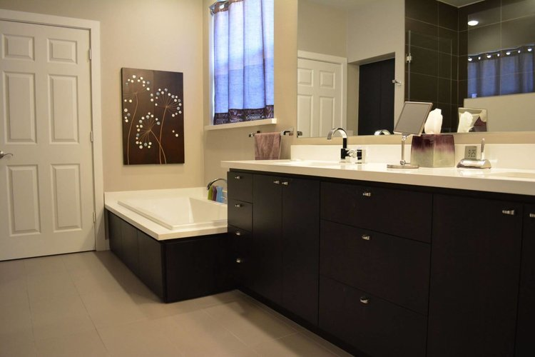 A bathroom with a vanity and a small tub