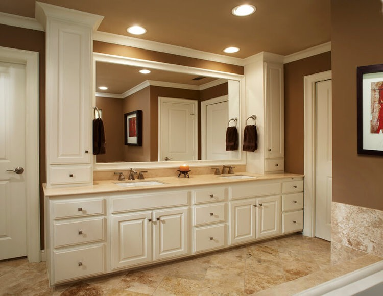 shot of a white vanity with two sinks, multiple cabinets, and drawers
