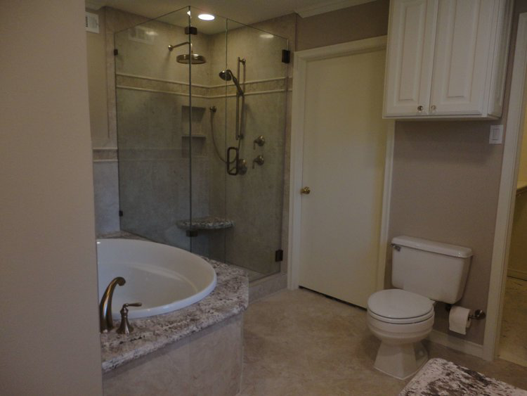 Walk-in shower with sleek tiling and frameless glass, designed to enhance comfort and modern bathroom style.