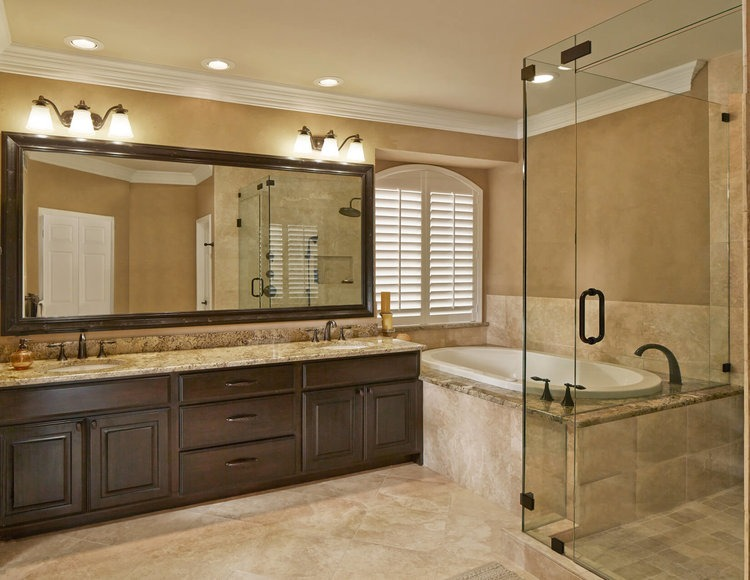a large wooden vanity with two sinks and lights over the mirror